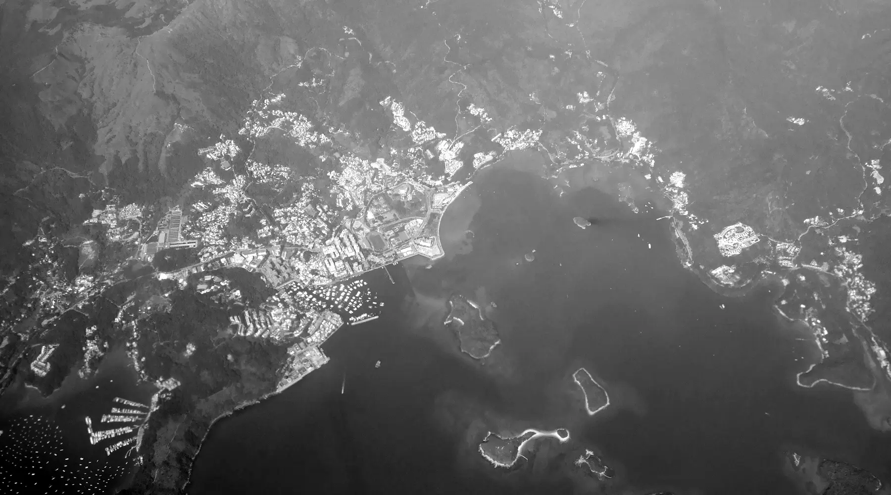 Sai Kung town and harbour, seen from the air, in black and white.