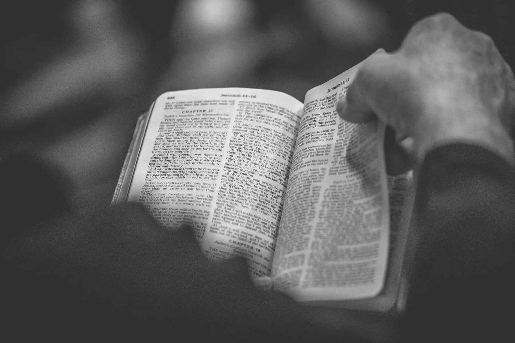 An open Bible, in black and white.